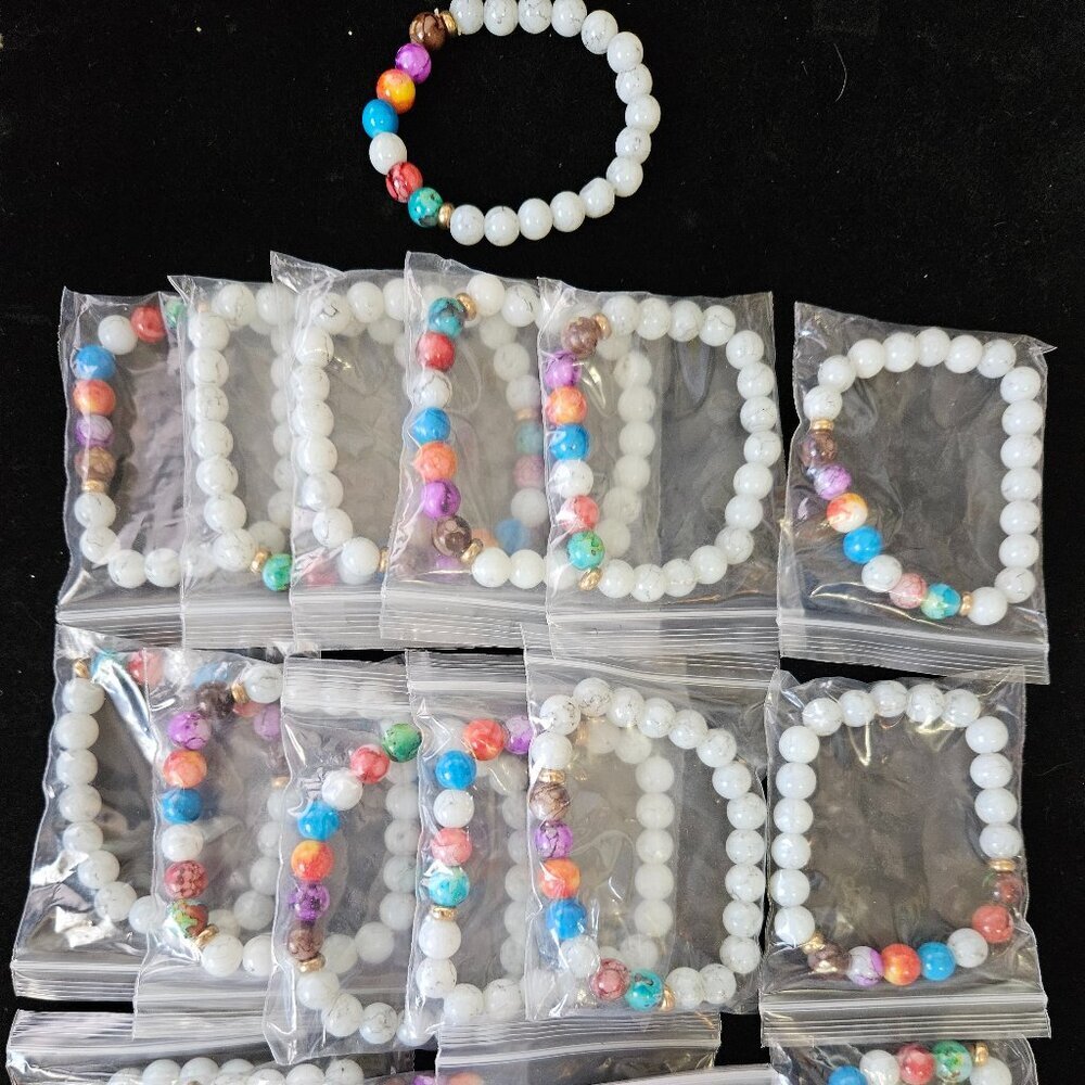 Lot of 19 stretch beaded bracelets featuring white stone beads with 7 chakra acc